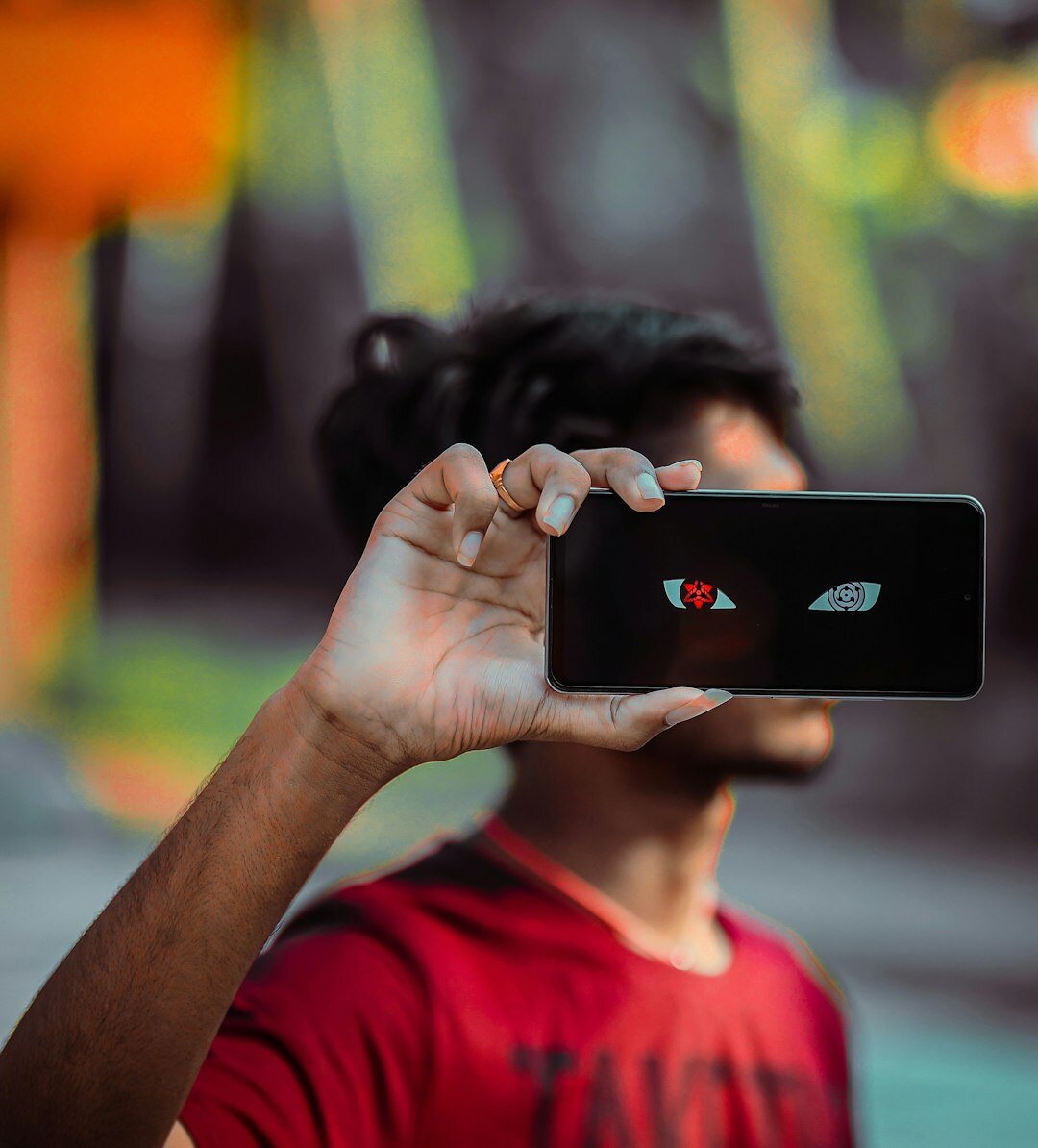 Professional man using smartphone for filming